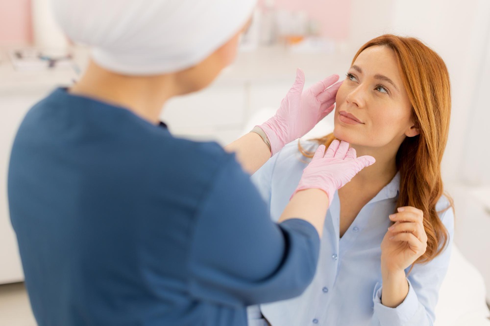 The doctor is examining the patient's jaw after genioplasty surgery.