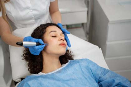 Woman receiving microneedling treatment from specialist