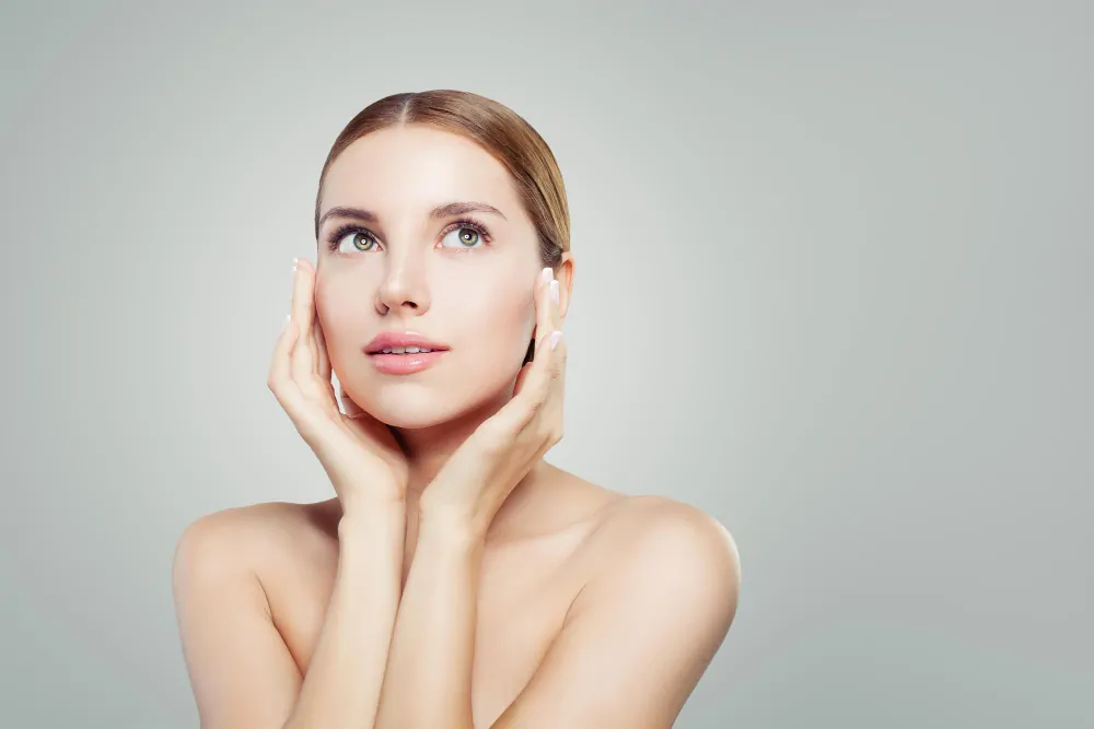 Woman with firm and youthful facial skin after skin tightening treatment